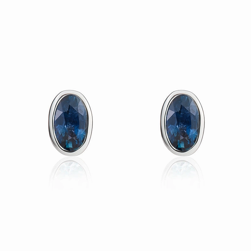9ct White Gold Sapphire 5x3mm Oval Rub Over Set Stud Earrings